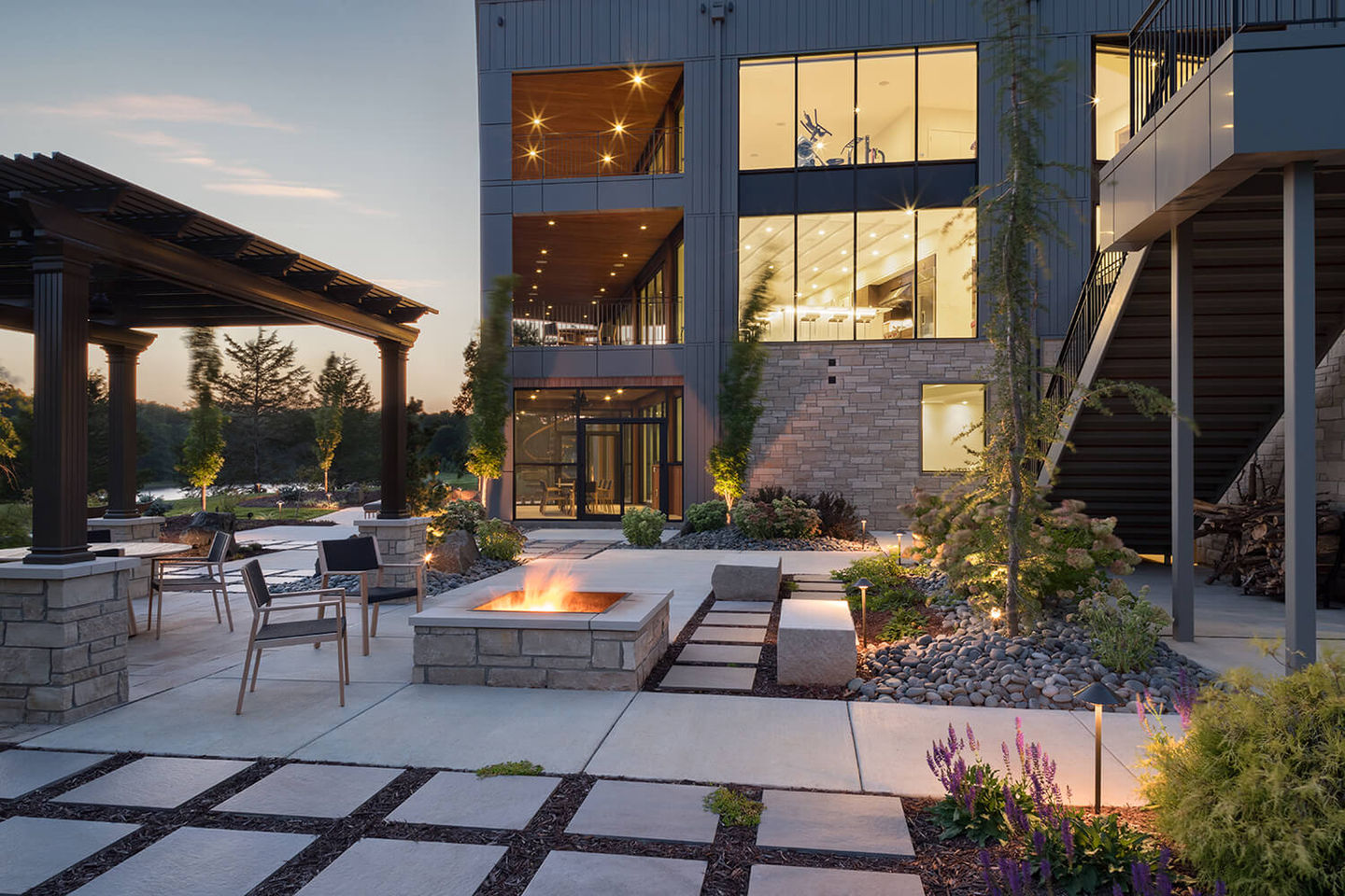 Modern lake house in Columbia, MO. Stunning modern architectural design with an indoor pool, rooftop deck and a wall of glass that creates an indoor/outdoor patio experience.
