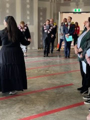 A group of people wearing formal attire walking into a hallway, marking the beginning of a celebration.