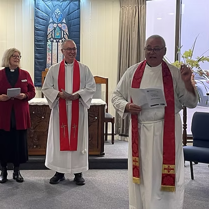 Three religious individuals leading a service in a chapel