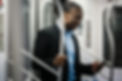 A person holding a handrail in metro.