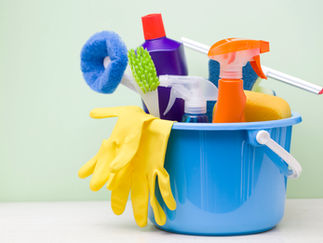 Bucket full of various cleaning products. 