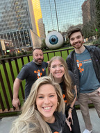 Several members of the ProSolve team pose for a selfie in front of a giant eyeball.