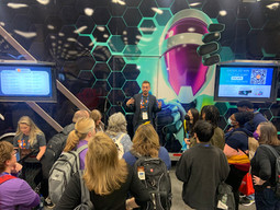 The ProSolve team presents in front of a large crowd at a conference.