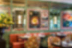 Colorful chairs, walls, and portraits in the main dining room at Ivy Chelsea Garden