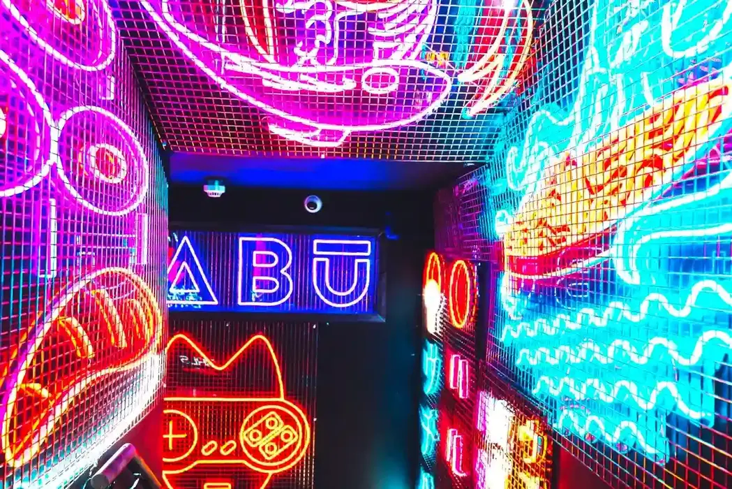Tabu London entry stairs decorated with bright LED signs.