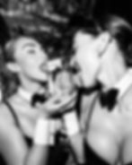 Rex Rooms Chelsea models holding a bottle of vodka.