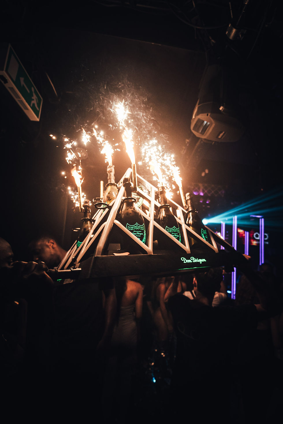 Waiters carrying a Dom Perignon champagne pyramid at Tape London, one of the best bottle show clubs in London