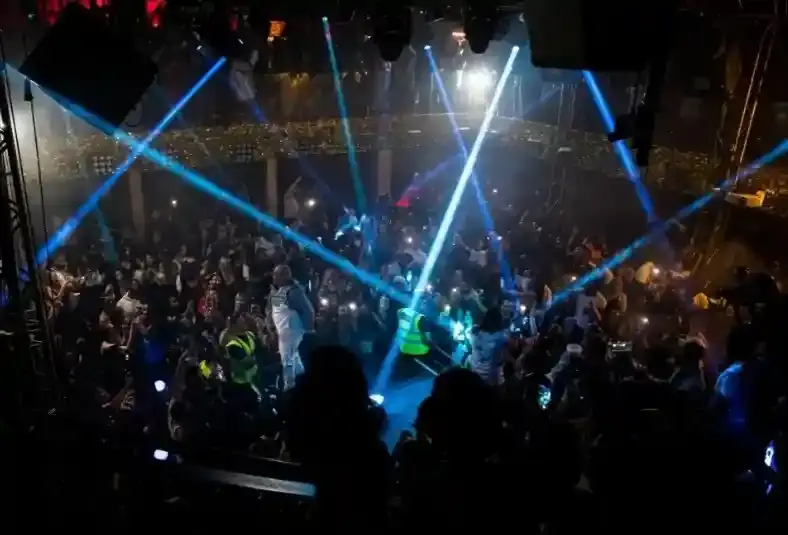 Proud Late club stage and tables completely packed for a Burna Boy performance.