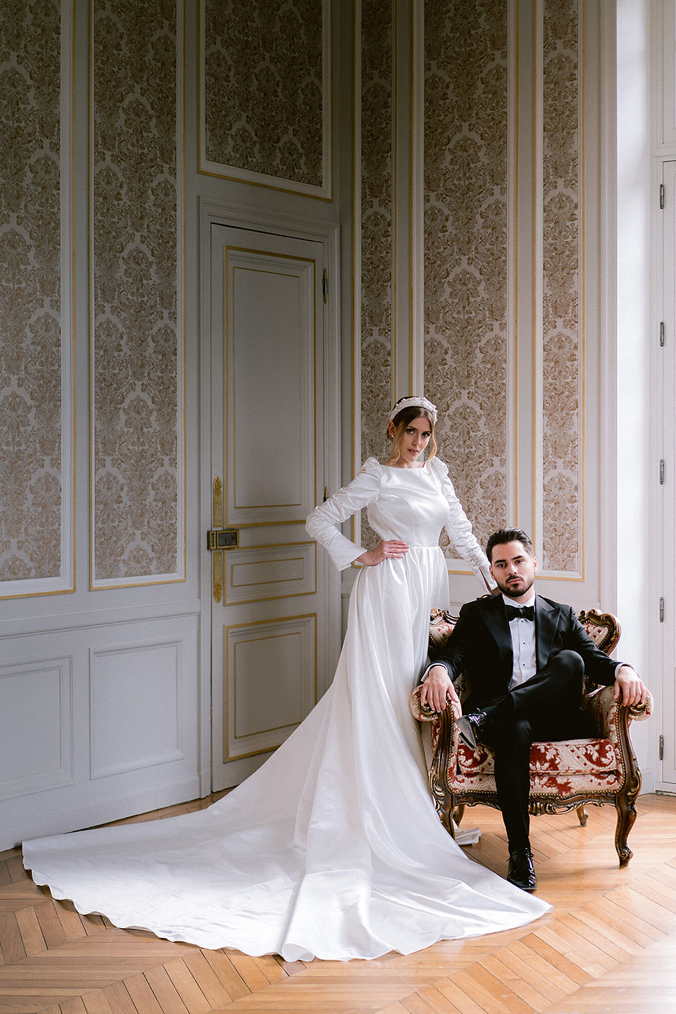 Portrait of the bride and groom standing in one of the salons of the Chateau de Nainville les Roches