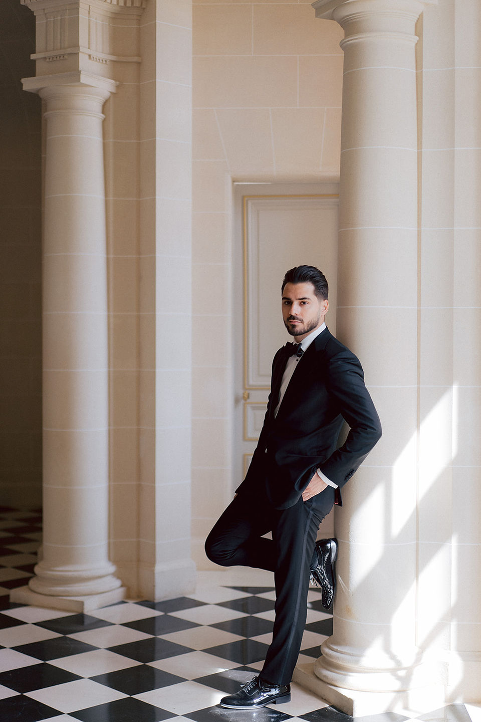 The groom standing in the hall of the Chateau de Nainville les Roches