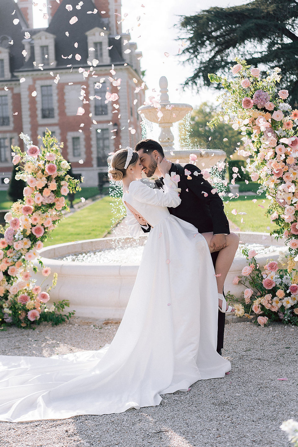 The bride and groom kiss at the end of their ceremony in the gardens of the Chateau de Nainville les Roches