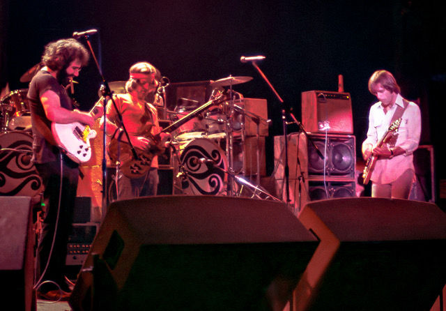 Jerry, Phil and Bob in the midst of a space jam, playing their guitars.