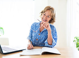 "Confident professional woman smiling at her desk, representing the mental sharpness, mood and renewed confidence that women's BHRT treatment at Hankins Hormonal Health Ohio can support"
Why this works: