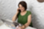 Stephanie Bell on phone call, using laptop
