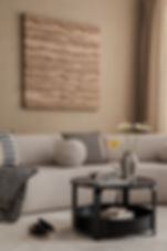 Calm, modern therapy waiting room with neutral tones, textured wall art, and minimal decor representing the safe, welcoming, and inclusive environment at Astacio Wellness
