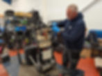 MLV Mobility technician Radek repairing a scooter in their Vulcan PLace Workshop