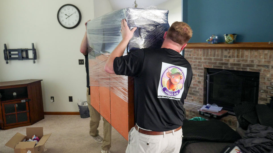 Prime Moovers employees moving furniture at a residential home in Springfield, IL.