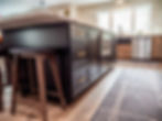 Black kitchen cabinetry from Dura Supreme and golden knob handles from Top Knobs Hardware, available for kitchen remodeling at Capitol Kitchen and Bath in Springfield, IL