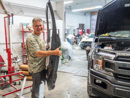 Crew working on auto body repair at Phoenix Collision in Springfield, IL.