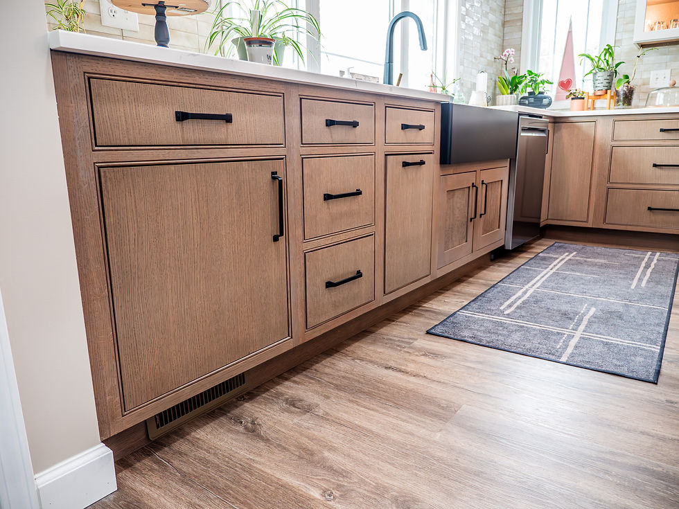 Brown kitchen cabinetry from Dura Supreme and black knob handles from Top Knobs Hardware, available for kitchen remodeling at Capitol Kitchen and Bath in Springfield, IL