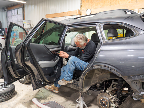 Crew working on auto body repair at Phoenix Collision in Springfield, IL.