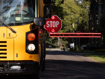 BusGates stop arm extended on the front of a school bus to stop illegal passing of school buses in real time.