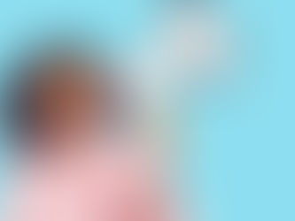 Girl in pink blouse and hoop earrings holds megaphone, shouting with joy against a bright blue background.