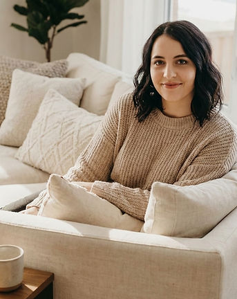 Founder seated in a calm, light-filled space, reflecting a thoughtful and approachable working style