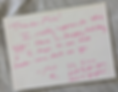 Handwritten pink thank-you note on white card for Mia, wishing happy holidays and praising her leadership, on a gray wood table.