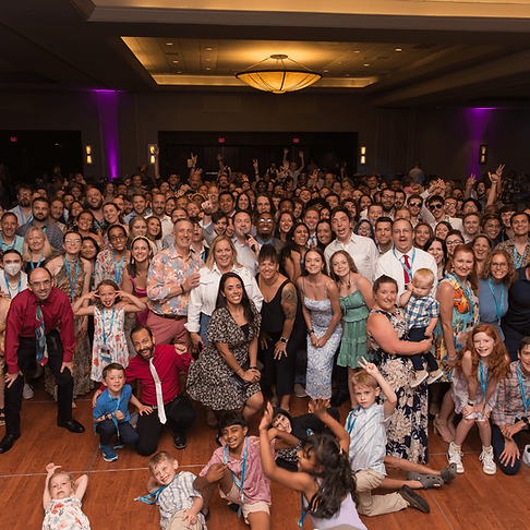 A large group of attendees enthusiastically posing together at an NSA conference.