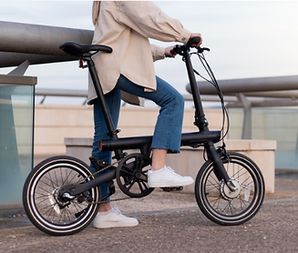 zero-emission-concept-cropped-woman-legs-riding-electric-bicycle-around-city-wearing-casua