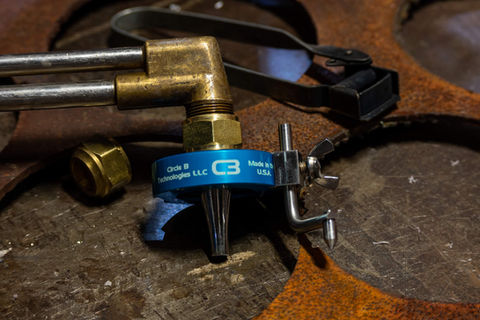 Several circles of various sizes cut out of metal using an oxy-fuel torch attachment