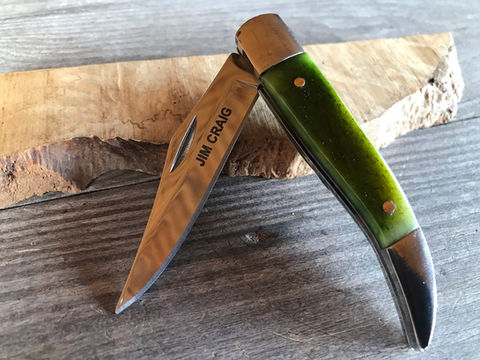 Green Dyed Camel Texas Toothpick Knife on a wooden block