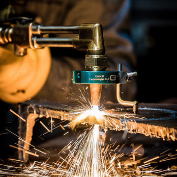Sparks flying from the welding attachment that cuts perfect circles