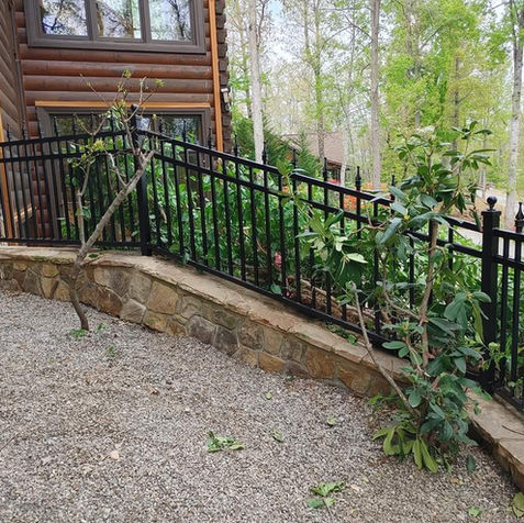 Outdoor metal fencing along driveway of house