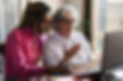 Multiracial senior and young woman having video call on laptop computer at home during cor