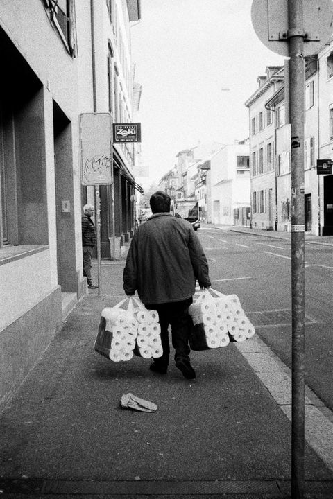 man hoarding toilet paper in covid corona times