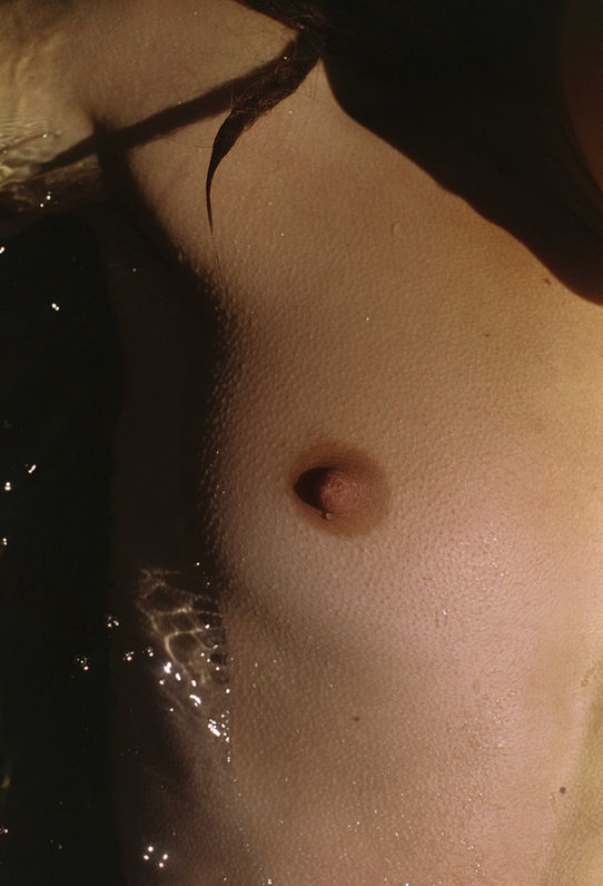 close up of a female nipple in cold water her skin showing goosebumps