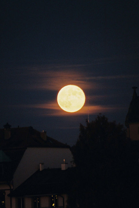 with 500mm telelens full moon over the city of Basel