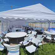 Tables and chair under a wedding tent