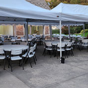 Tents canopies tables and chairs at a wedding
