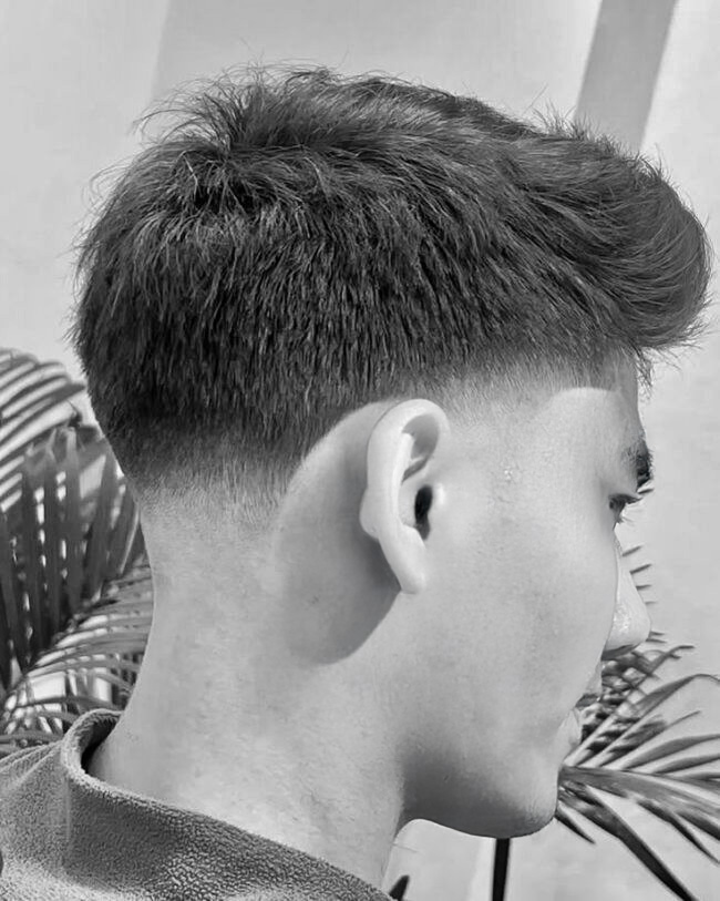 Barber and client consult about fade haircut