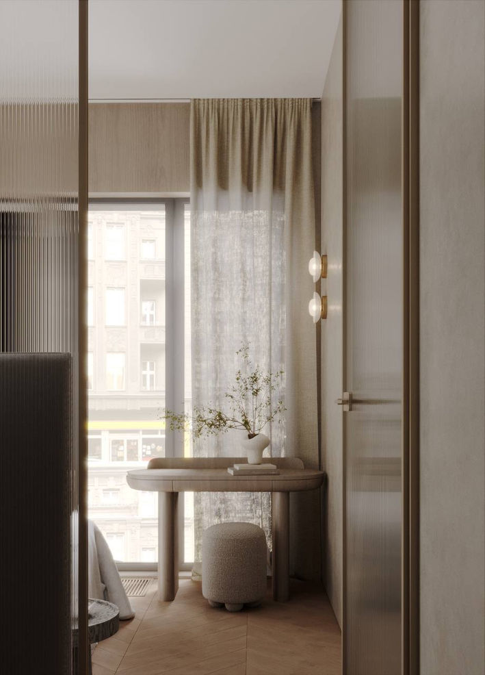 Soft, minimalist nook with a small round table by a window, sheer curtains, warm wood tones, and a vase with delicate branches.