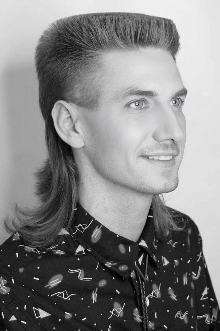 A classic mullet hairstyle, featuring a voluminous top and flowing back, capturing the iconic essence of this retro fashion statement.