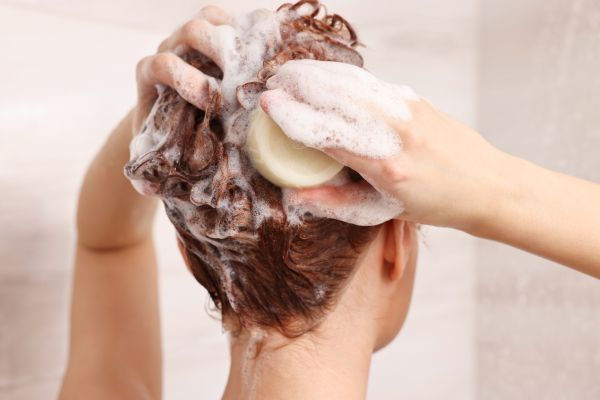 woman using a shampoo bar