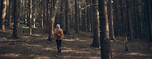 Woman Walking in Forest