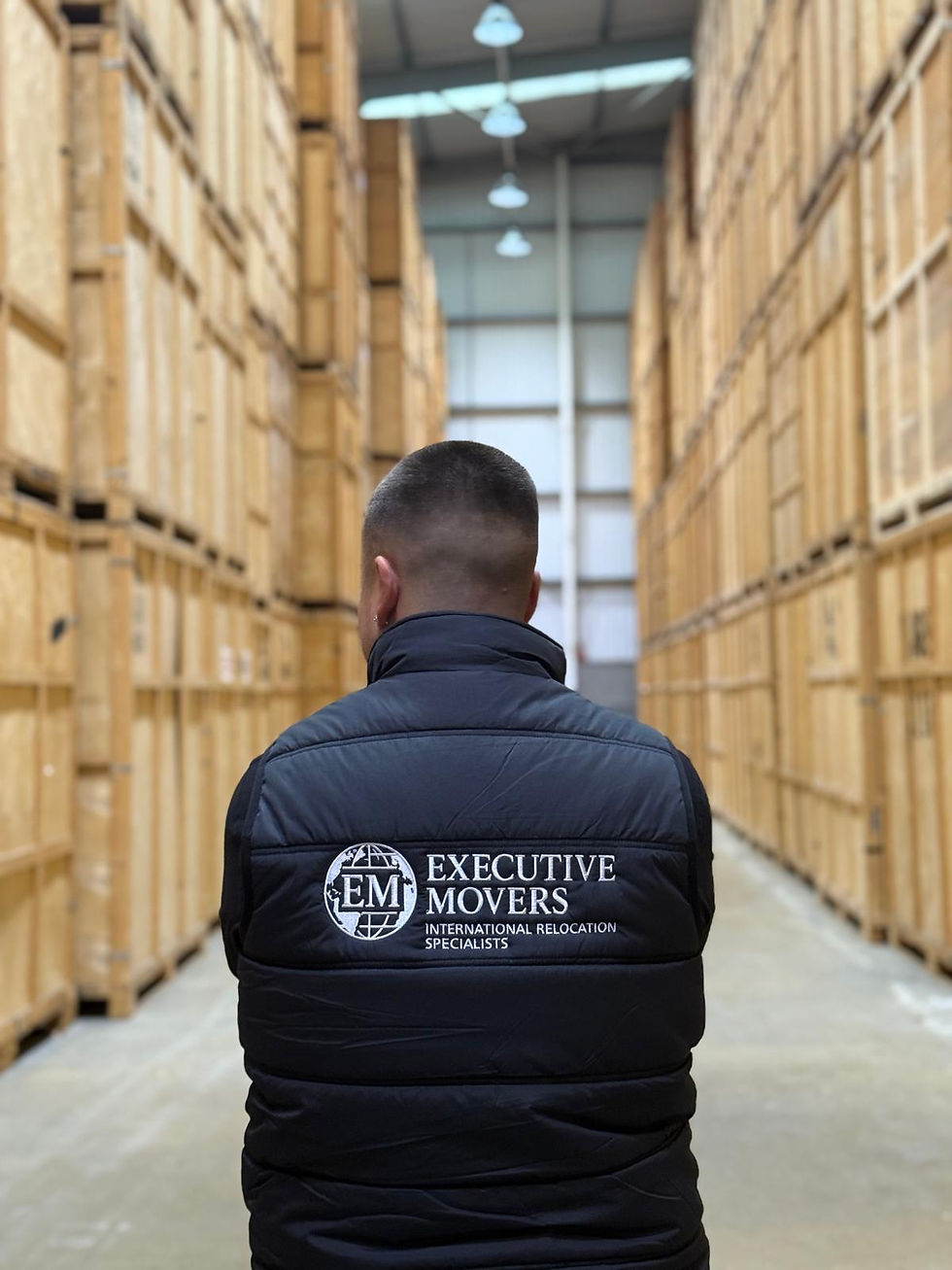 High-angle view of sealed timber storage containers inside a removals warehouse
