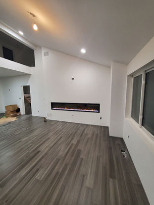 Angled ceiling room with built in modern fireplace