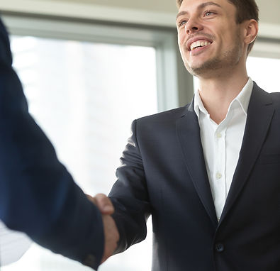 smiling-young-businessman-wearing-black-suit-shaking-male-hand (1).jpg