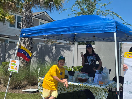 Children learning entrepreneurship and generosity through a lemonade stand.
